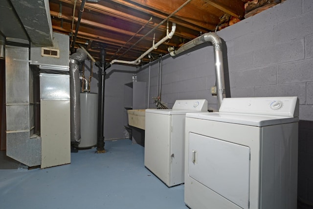 laundry room featuring laundry area, independent washer and dryer, visible vents, water heater, and heating unit