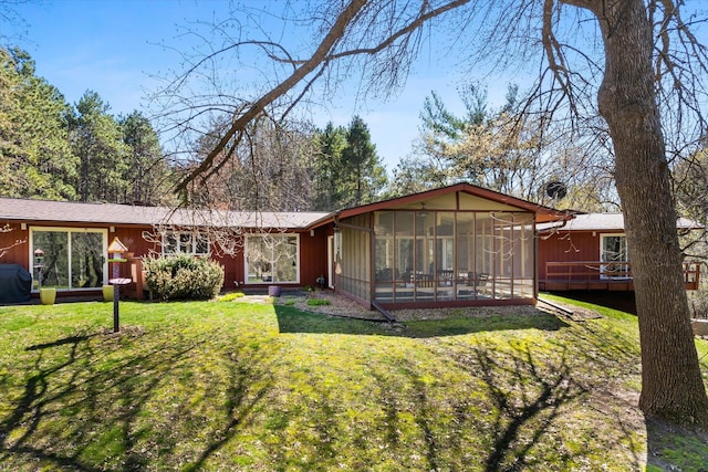 1206 Pinecrest Ln, New Richmond, WI 54017 - rear view of house with a sunroom, a yard, and a deck