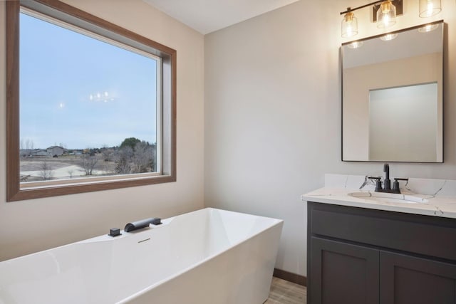 bathroom with a freestanding bath and vanity
