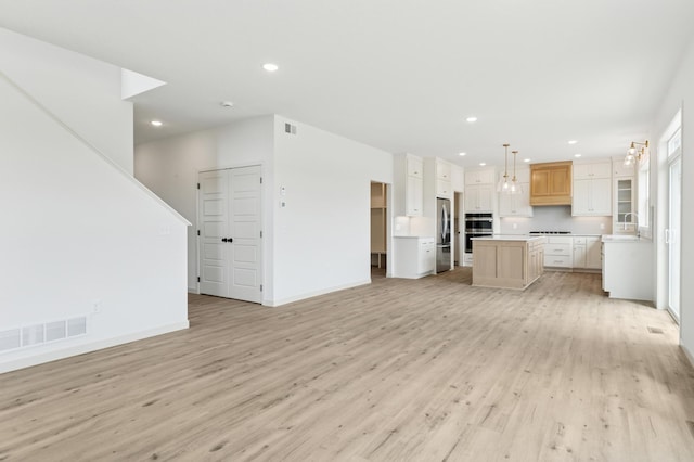 21959 Edison Ct NW, East Bethel, MN 55011 - unfurnished living room featuring light wood finished floors and recessed lighting