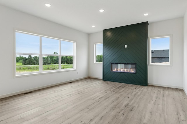 21959 Edison Ct NW, East Bethel, MN 55011 - unfurnished living room with wood finished floors, recessed lighting, and a large fireplace