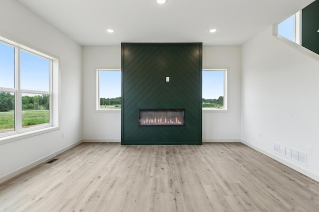21959 Edison Ct NW, East Bethel, MN 55011 - unfurnished living room featuring wood finished floors, recessed lighting, and a fireplace