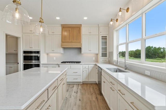 21959 Edison Ct NW, East Bethel, MN 55011 - kitchen with appliances with stainless steel finishes, recessed lighting, light wood-style flooring, white cabinetry, and hanging light fixtures