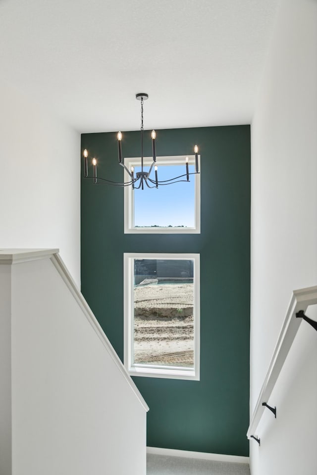 21959 Edison Ct NW, East Bethel, MN 55011 - staircase featuring a chandelier and carpet floors