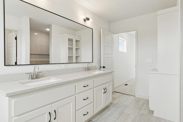 21959 Edison Ct NW, East Bethel, MN 55011 - bathroom with double vanity and wood finished floors