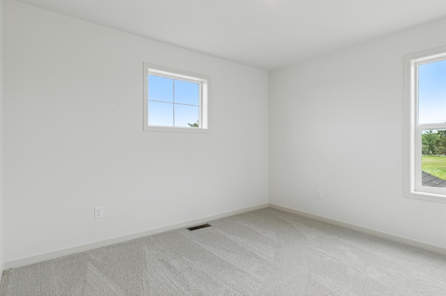 21959 Edison Ct NW, East Bethel, MN 55011 - spare room featuring plenty of natural light and light carpet