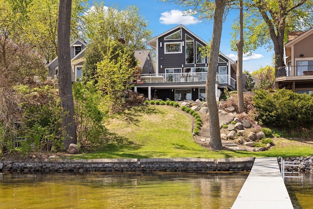 176 Peninsula Rd, Medicine Lake, MN 55441 - rear view of property with a deck with water view and a lawn