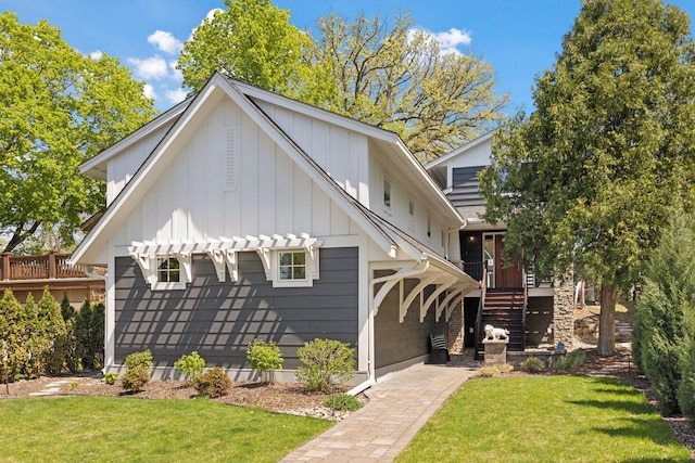 176 Peninsula Rd, Medicine Lake, MN 55441 - view of front facade with board and batten siding, a front lawn, stairs, a deck, and a pergola