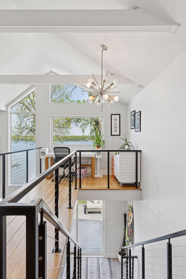 176 Peninsula Rd, Medicine Lake, MN 55441 - stairway with a chandelier, vaulted ceiling, healthy amount of natural light, and baseboards