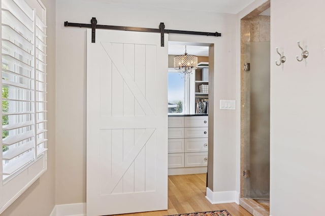 176 Peninsula Rd, Medicine Lake, MN 55441 - interior space featuring light wood-style floors, a barn door, and baseboards
