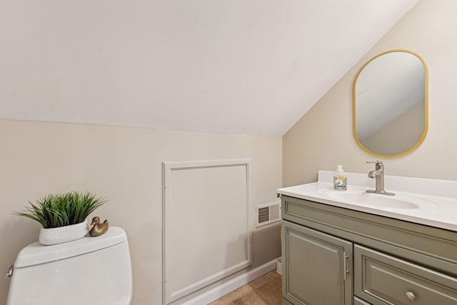 176 Peninsula Rd, Medicine Lake, MN 55441 - bathroom featuring vanity, vaulted ceiling, and toilet