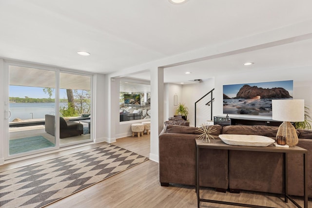 176 Peninsula Rd, Medicine Lake, MN 55441 - living room featuring light wood-style flooring, a water view, recessed lighting, and baseboards