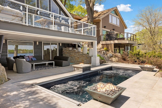 176 Peninsula Rd, Medicine Lake, MN 55441 - rear view of property featuring a patio, an outdoor living space with a fire pit, an outdoor pool, and stairway