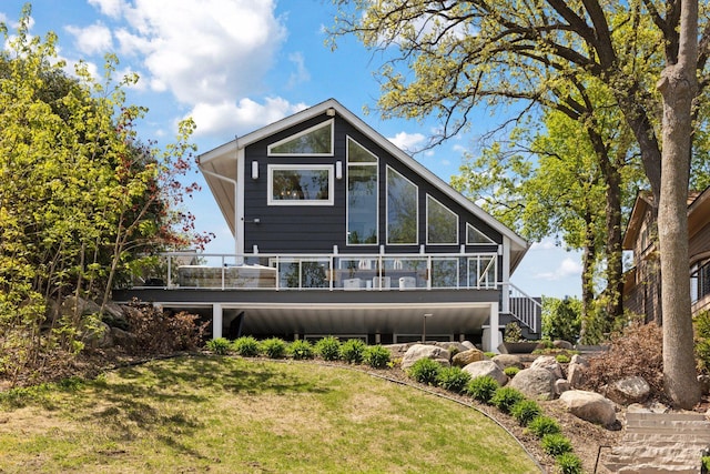 176 Peninsula Rd, Medicine Lake, MN 55441 - back of house featuring a sunroom, a lawn, and stairs