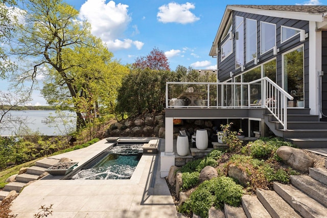 176 Peninsula Rd, Medicine Lake, MN 55441 - view of yard featuring a water view, stairs, an outdoor pool, and a jacuzzi