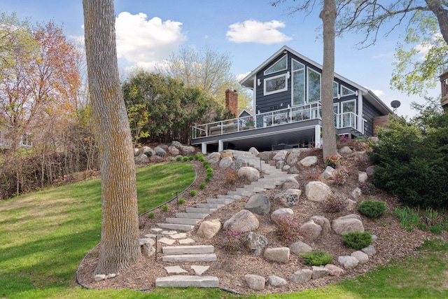 176 Peninsula Rd, Medicine Lake, MN 55441 - back of property with stairs, a lawn, and a deck