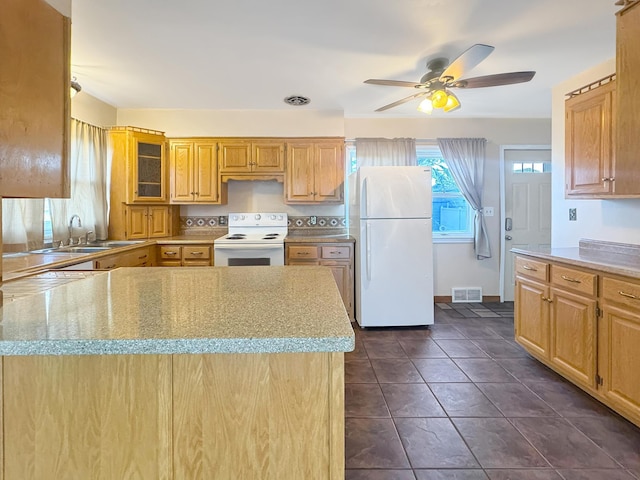 kitchen with visible vents, a ceiling fan, white appliances, light stone countertops, and a sink