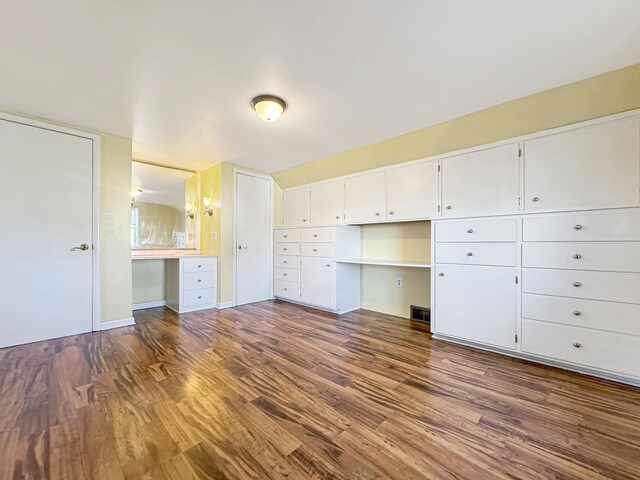 unfurnished bedroom with visible vents and wood finished floors