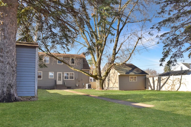 view of yard with cooling unit, fence, and entry steps