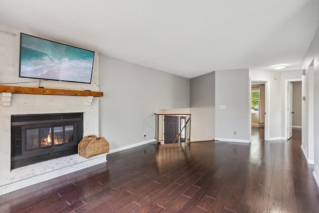 1112 Gabbert Cir, Eagan, MN 55123 - unfurnished living room with wood finished floors, baseboards, and a brick fireplace