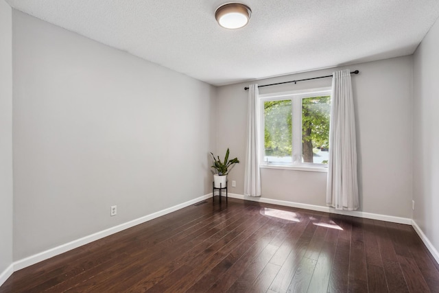 1112 Gabbert Cir, Eagan, MN 55123 - unfurnished room featuring wood-type flooring, baseboards, and a textured ceiling