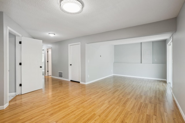 1112 Gabbert Cir, Eagan, MN 55123 - empty room featuring light wood finished floors, a textured ceiling, and baseboards