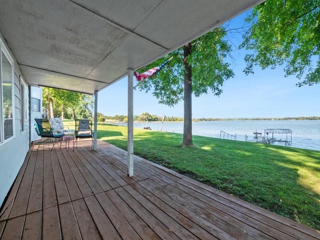 wooden deck featuring a yard and a water view