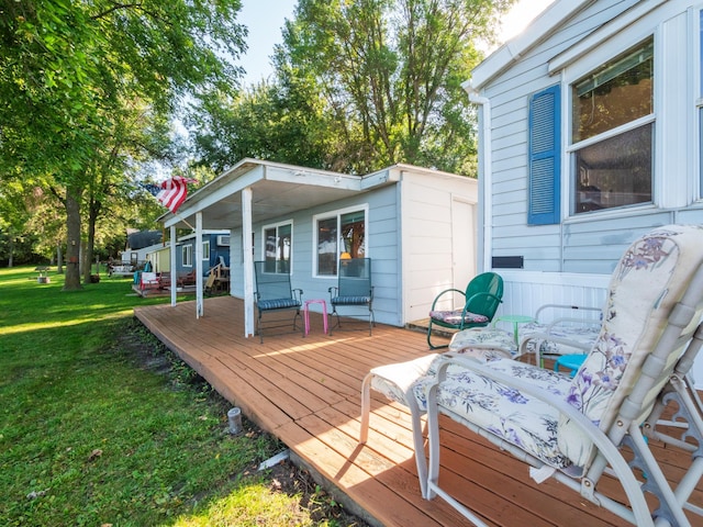 wooden deck featuring a lawn
