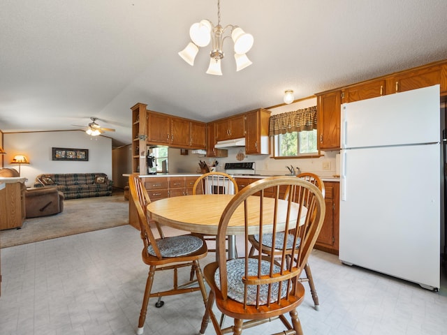 dining room featuring lofted ceiling and ceiling fan with notable chandelier
