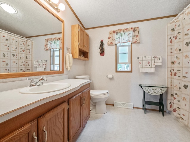bathroom featuring tile patterned floors, vanity, crown molding, and a textured ceiling