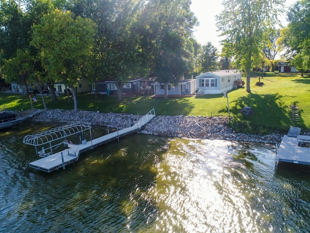 dock area featuring a water view and a lawn