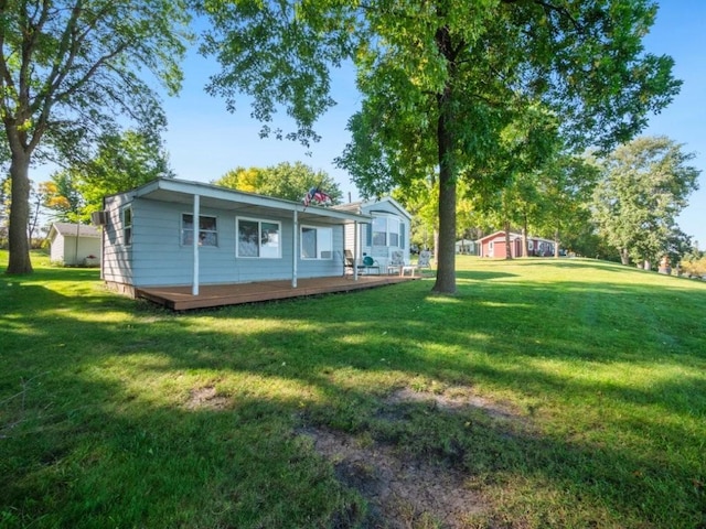 view of yard featuring an outdoor structure and a deck