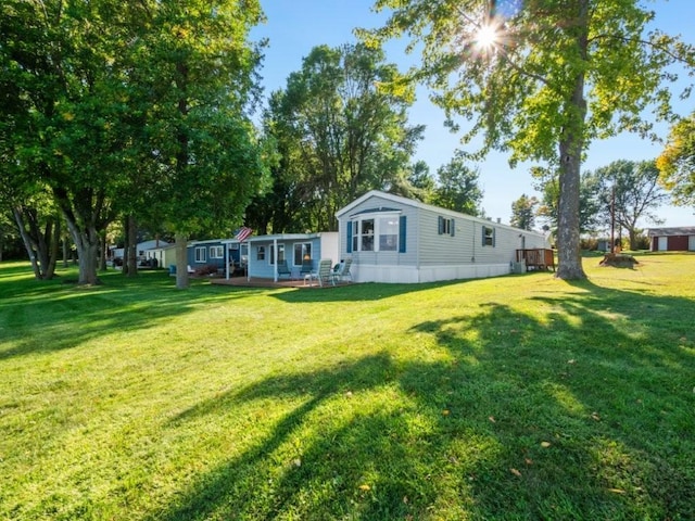 back of property with a lawn