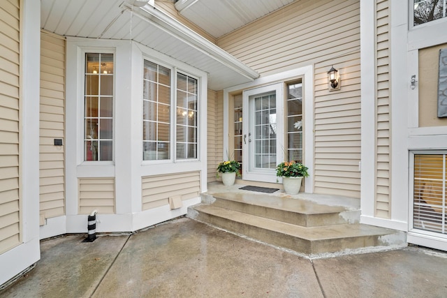 view of exterior entry with a patio