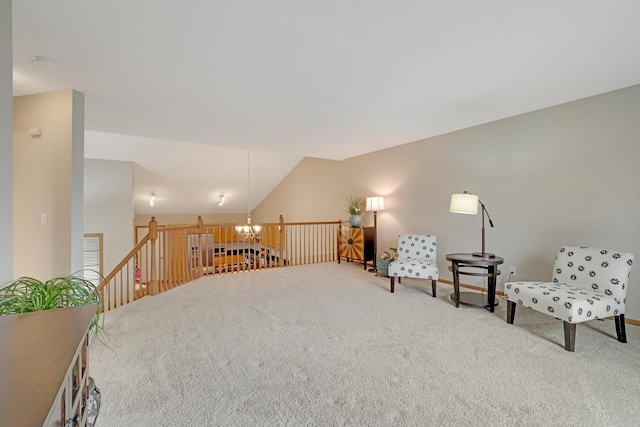 living area with a notable chandelier, an upstairs landing, lofted ceiling, and carpet