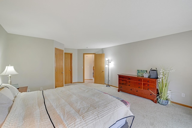 bedroom with baseboards and carpet flooring