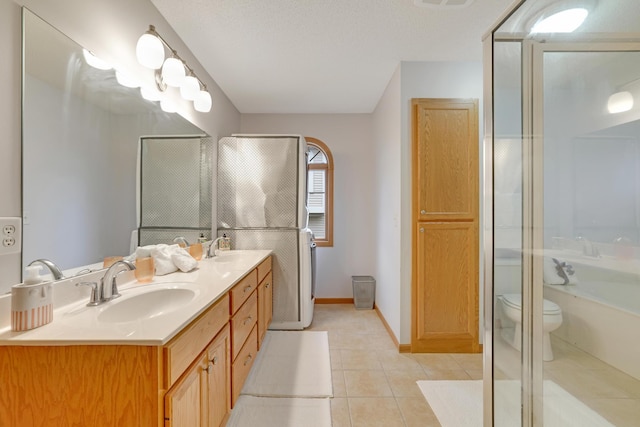full bath with tile patterned floors, double vanity, toilet, a sink, and a shower