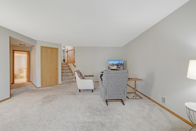 sitting room featuring baseboards, visible vents, stairs, and carpet floors