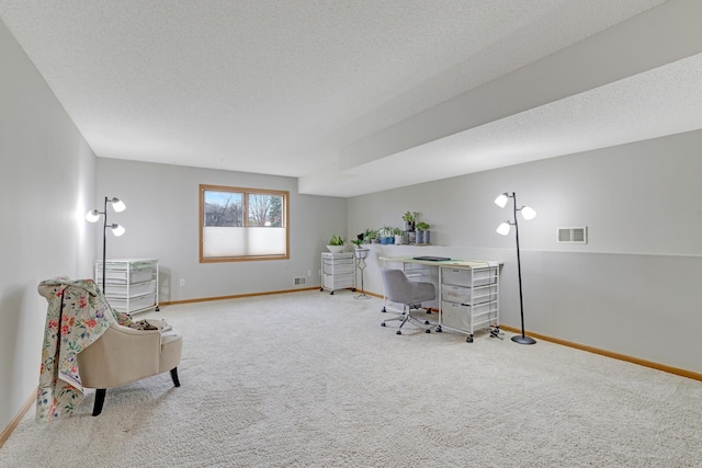 carpeted office space featuring visible vents and baseboards