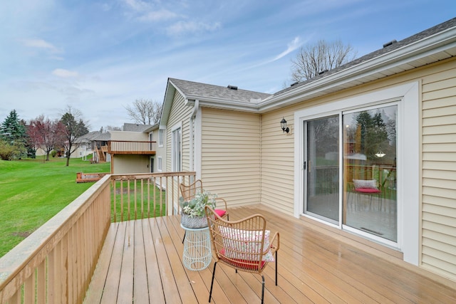 wooden terrace with a lawn
