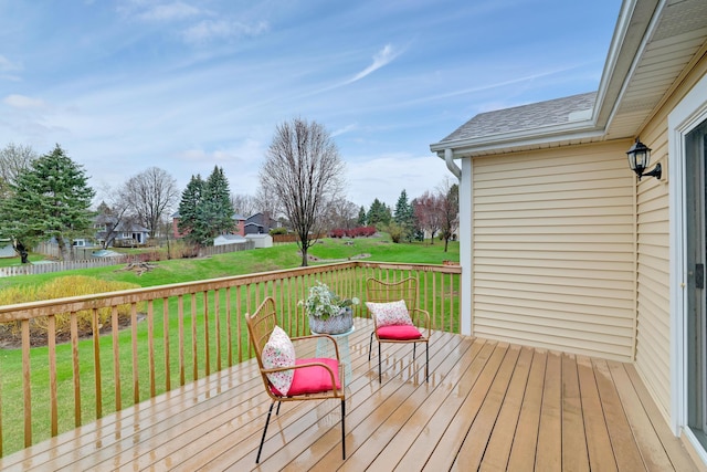 wooden deck with a lawn