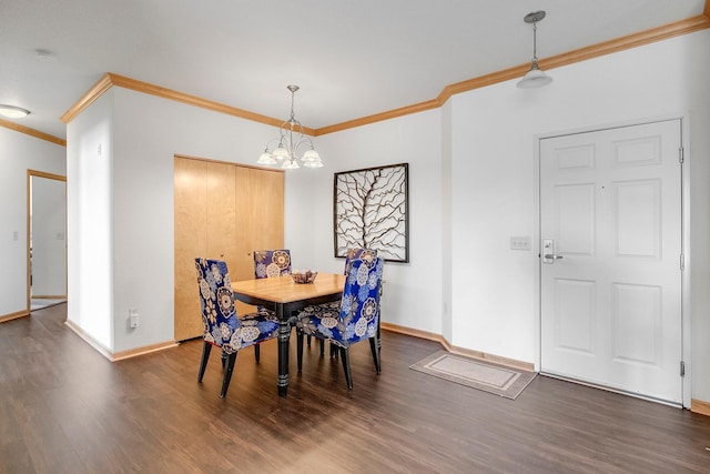 dining area featuring ornamental molding, wood finished floors, baseboards, and a chandelier