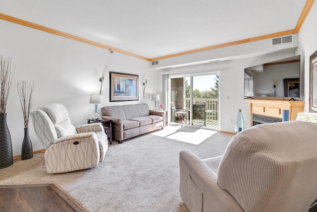 living room featuring carpet floors, ornamental molding, baseboards, and a fireplace