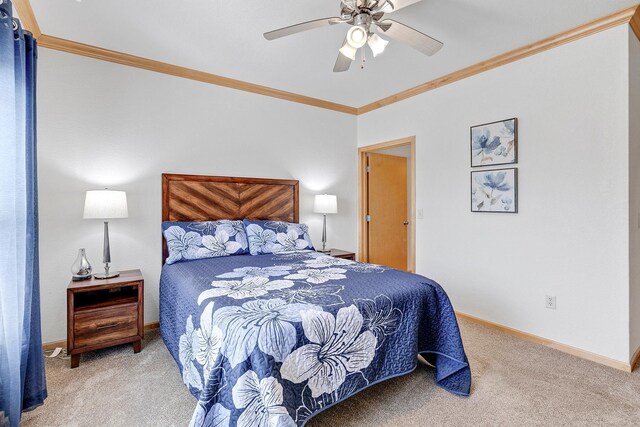 carpeted bedroom featuring crown molding, baseboards, and a ceiling fan