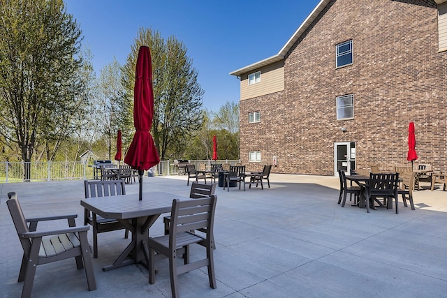 view of patio / terrace featuring outdoor dining area and fence