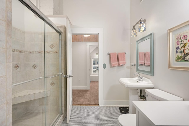 full bathroom with baseboards, tile patterned floors, toilet, and a shower stall