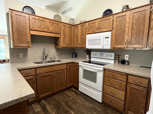 kitchen with white appliances, a sink, decorative backsplash, and brown cabinetry
