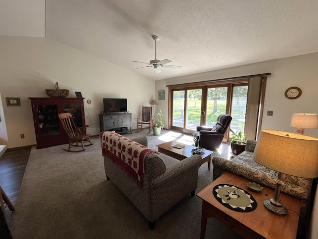living area featuring ceiling fan, lofted ceiling, wood finished floors, and a textured ceiling