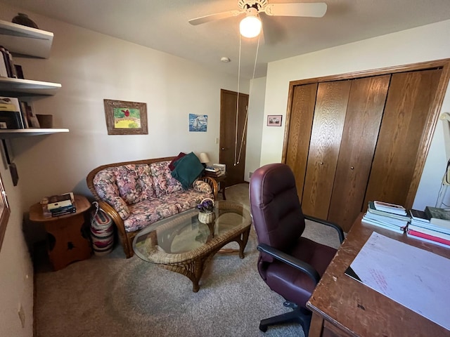 carpeted home office featuring ceiling fan