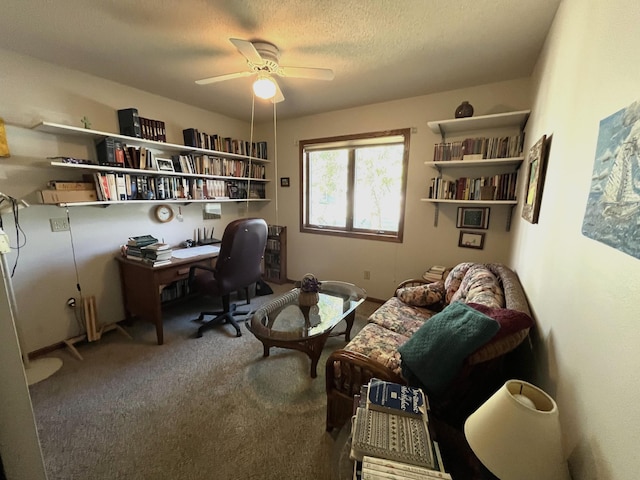 home office with ceiling fan, carpet, and a textured ceiling